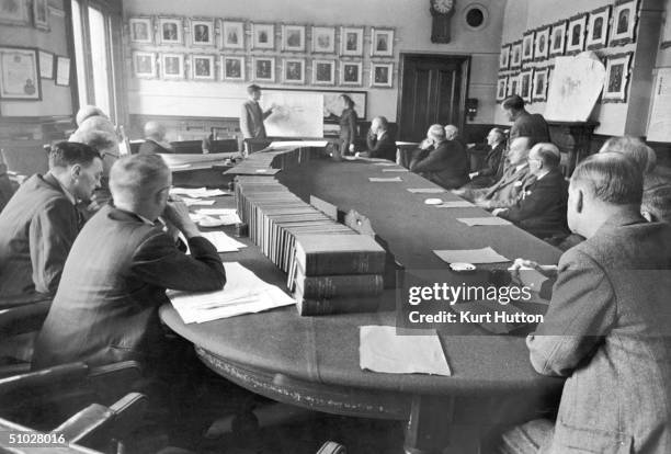 The Middlesbrough Joint Reconstruction Committee hold their monthly meeting in the town hall to discuss progress, 28th October 1944. Original...