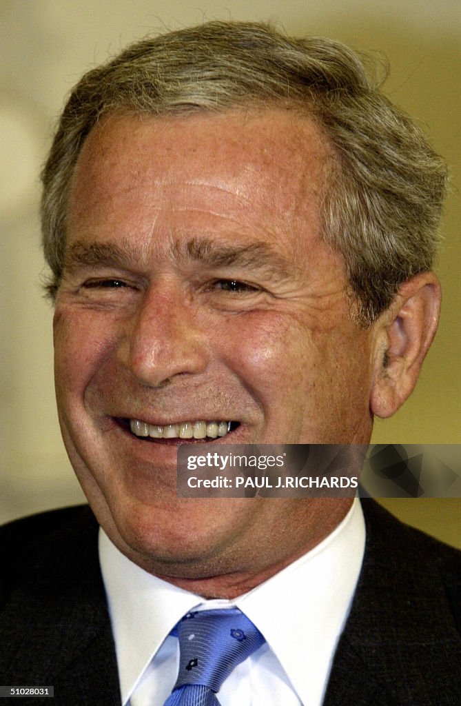 US President George W. Bush laughs as Wh