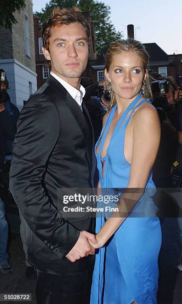 Jude Law and Sienna Miller leave David Frost's Summer Party at Carlisle Square on July 6, 2004 in London.