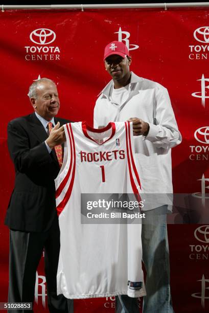 Houston Rockets Owner Leslie Alexander and Tracy McGrady of the Houston Rockets hold up McGrady's jersey during a press conference to introduce the...