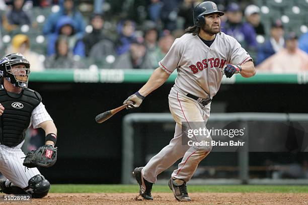 Johnny Damon of the Boston Red Sox makes a hit during the game against the Colorado Rockies on June 17, 2004 at Coors Field in Denver, Colorado. The...