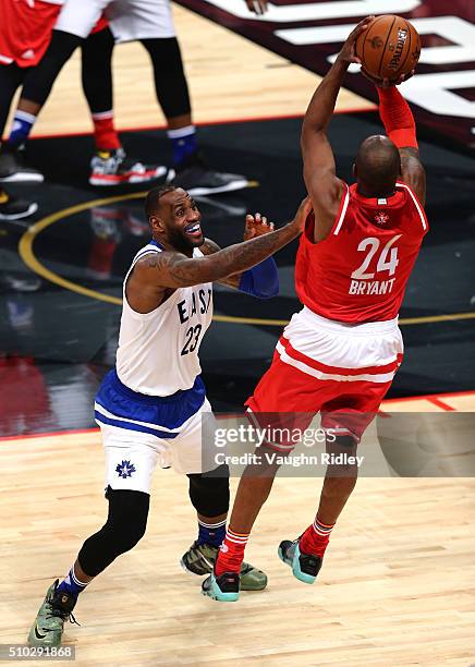 LeBron James of the Cleveland Cavaliers and the Eastern Conference smiles as he defends Kobe Bryant of the Los Angeles Lakers and the Western...