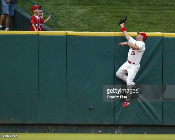 Jim Edmonds of the St. Louis Cardinals robs Adam Dunn of the Cincinnati Reds of a home run in the second inning July 6, 2004 at Busch Stadium in St....