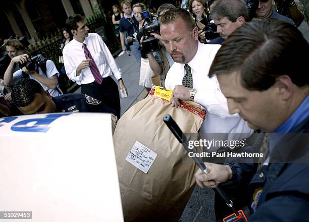 Police officers retrieve evidence from a Manhattan apartment building at 10 East 29th street where the body of Eric Douglas, youngest son of actor...