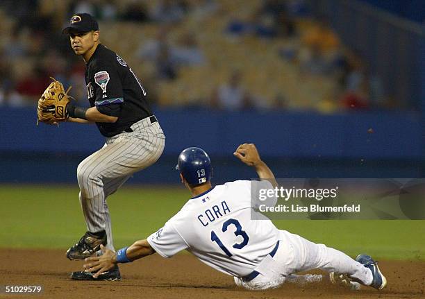 Alex Cintron of the Arizona Diamondbacks turns a successful doubleplay over a sliding Alex Cora of the Los Angeles Dodgers in the 4th inning on a...