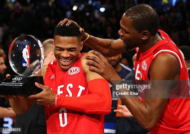 Russell Westbrook of the Oklahoma City Thunder and the Western Conference is congratulated by teammate Kevin Durant after defeating the Eastern...