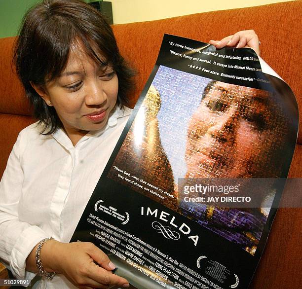 Based Filipino filmmaker Ramona Diaz holds a poster in Manila 07 July 2004, promoting her movie "imelda" which tracks former first lady Imelda...