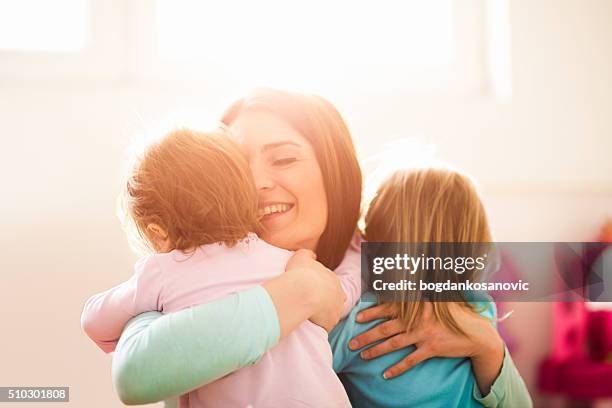 modern mother with daughters - family with two children stock pictures, royalty-free photos & images