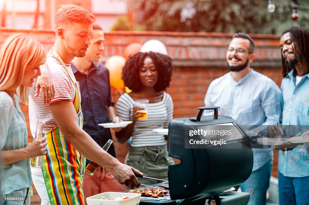 Young People Havin Fun At Barbecue Party.