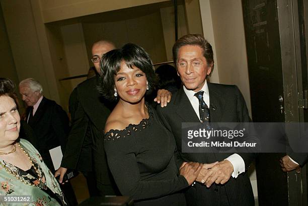 American talk show host Oprah Winfrey stands with Fashion designer Valentino as they attend the Valentino presentation of their Spring/Summer 2005...