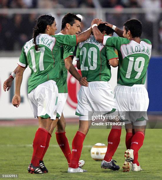 Mexican players Francisco Palencia, Jared Borgetti and Jaime Lozano congratulate Ricardo Osorio after scoring a goal against Uruguay during their...