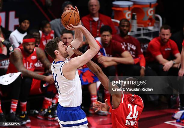 Pau Gasol of the Chicago Bulls and the Eastern Conference shoots against Kobe Bryant of the Los Angeles Lakers and the Western Conference in the...