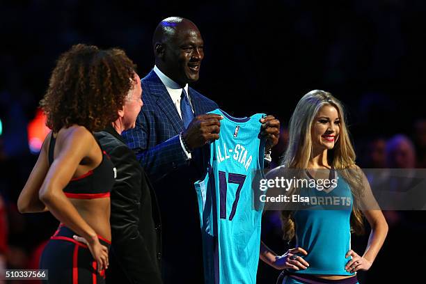 Larry Tanenbaum presents NBA Hall of Famer and Charlotte Hornets owner Michael Jordan a jersey signifying Charlotte as the host city for the 2017...