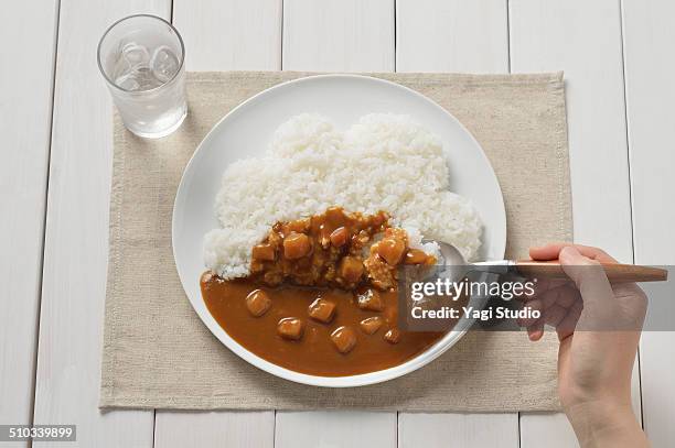 curry and clouds - spoon in hand stock pictures, royalty-free photos & images