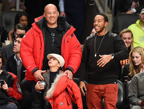 Actor Vin Diesel, son Vincent Sinclair and Ludacris attend the 2016 NBA All-Star Game at Air Canada Centre on February 14, 2016 in Toronto, Canada.