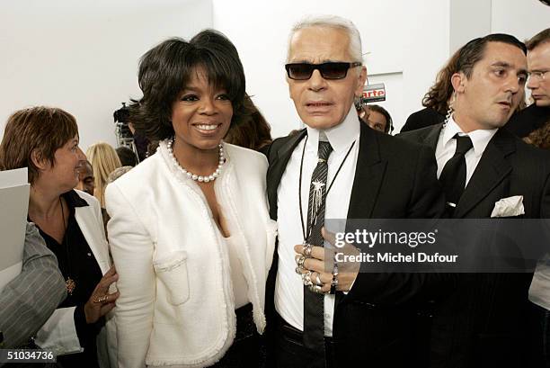 Oprah Winfrey with Karl Lagerfeld attend the Chanel Spring/Summer 2005 Fashion Show during Paris Fashion Week on July 7, 2004 in Paris, France.