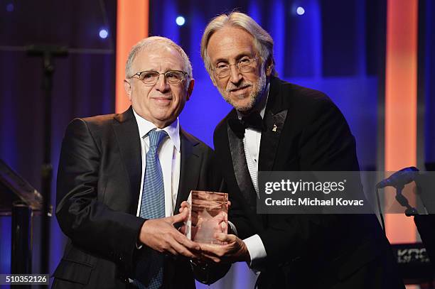 Honoree Irving Azoff accepts the President's Merit Award onstage from National Academy of Recording Arts and Sciences President Neil Portnow during...