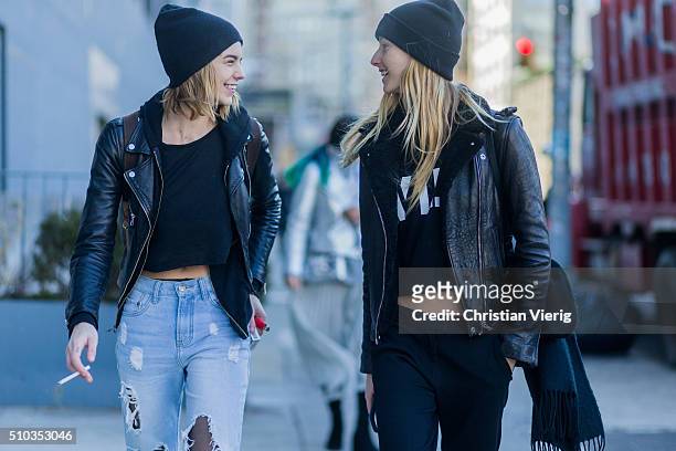 Fashion models wearing ripped blue denim jeans, a black leather jacket seen outside Lacoste during New York Fashion Week: Women's Fall/Winter 2016 on...