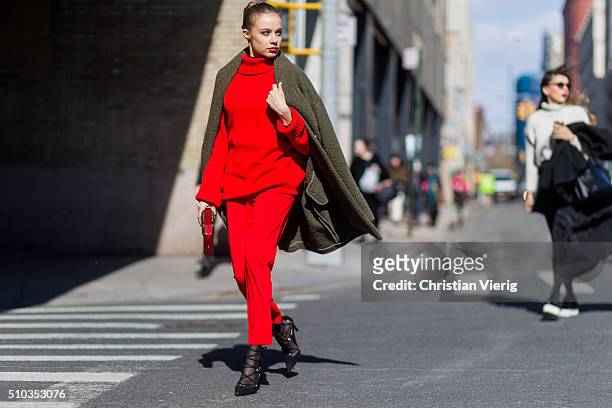 Xenia Tchoumitcheva is wearing red sweater and pants by Pinko seen outside Rebecca Minkoff during New York Fashion Week: Women's Fall/Winter 2016 on...