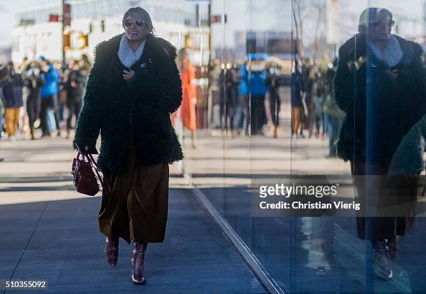 Helena Bordon is wearing By Helena Bordon sunglasses, a Tods bag and a dark green fake fur coat seen outside Tibi during New York Fashion Week:...