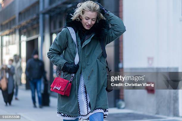 Zanita Whittington is wearing a green parka and a red bag seen outside Tibi during New York Fashion Week: Women's Fall/Winter 2016 on February 13,...
