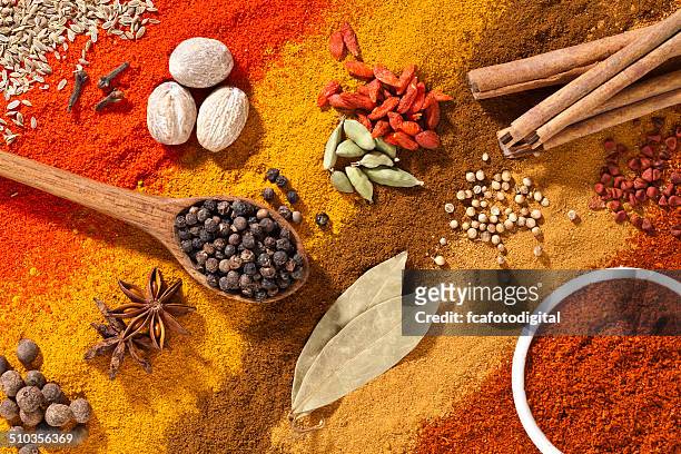 colorful exotic spices composition shot directly above - pimientos stockfoto's en -beelden