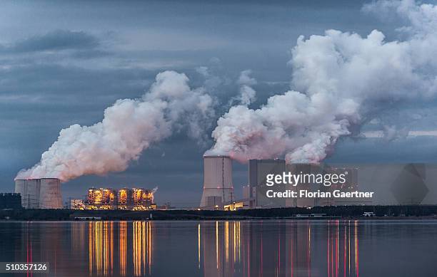 Boxberg Power Station is reflected in the lake 'Baerwalder See' in Klitten on February 14, 2016. This lignite-fired power station is the fourth...