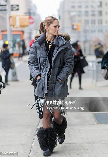 Sofia Sanchez de Betak wearing a Moncler jacket and a black white Dion Lee skirt with fringes and black fake fur boots seen outside Lacoste during...