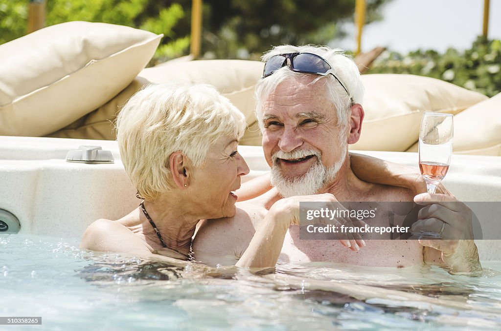Mature couple having fun togetherness in the pool