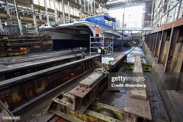 Employees work on a Thames Clipper catamaran at Turks boatyard in Chatham, U.K., on Thursday, Oct. 29, 2015. The Thames Clipper river bus service...