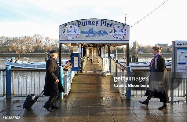 Passengers arrive at Putney pier to board a Thames Clipper service in London, U.K., on Friday, Feb. 12, 2016. The Thames Clipper river bus service...