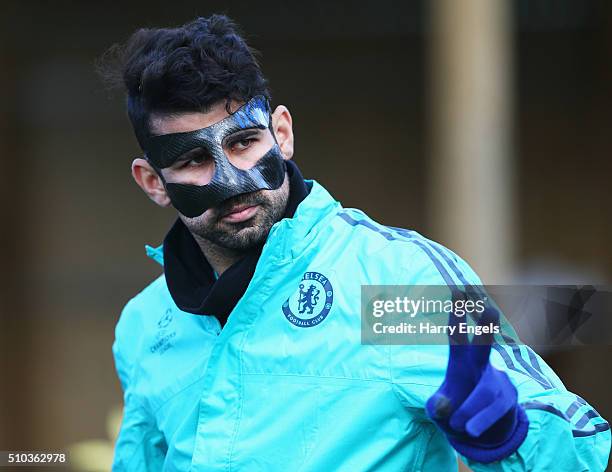 Diego Costa of Chelsea wears a protective face mask during a Chelsea training session ahead of their UEFA Champions League round of 16 match against...