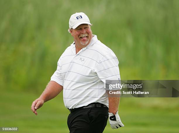 Craig Stadler smiles as he walks off on the first tee during the first round of the Ford Senior Players Championship at the TPC of Michigan on July...