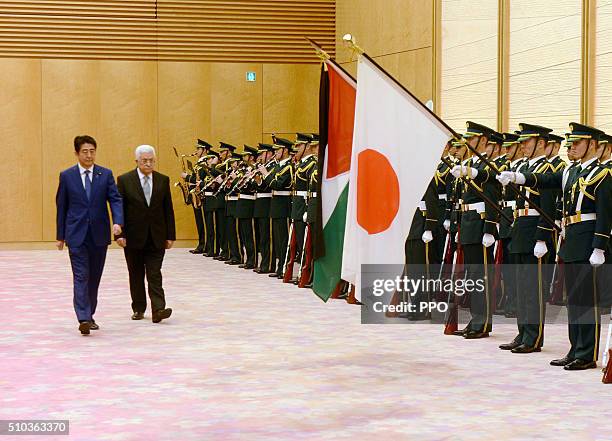 In this handout image supplied by the Palesinian President's Office , Palestinian president Mahmoud Abbas inspects an honour guard with Japanese...