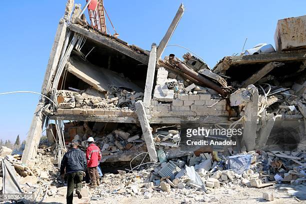 Rescue workers and civilians inspect the debris of a collapsed hospital, belongs to humanitarian aid organization "Doctors Without Borders" to save...