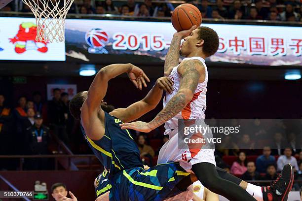 Michael Beasley of Shandong Golden Stars shoots the ball against Ike Diogu of Guangdong Southern Tigers during the Chinese Basketball Association...