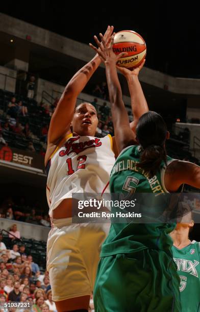 Natalie Williams of the Indiana Fever shoots over Stacey Lovelace-Tolbert of the Minnesota Lynx on July 8, 2004 at Conseco Fieldhouse in...