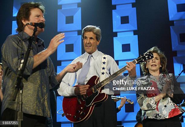 Democratic presidential candidate John Kerry plays a guitar appear at a Kerry/Edwards 2004 Victory concert at Radio City Music Hall in New York City...