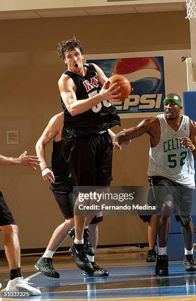 Albert Miralles of the Miami Heat rebounds against the Boston Celtics during a NBA Pepsi Pro Summer League game July 8, 2004 at the RDV Sportsplex in...