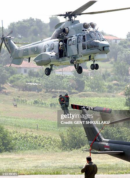 Soldiers rapel out of a helicopter during a multi-national military exercise including Italy, Greece, Macedonia and NATO Air Forces based in Albania,...