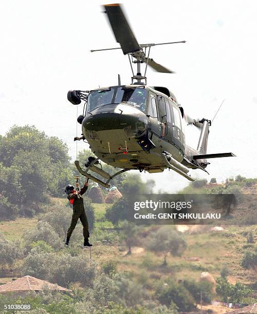 Soldiers rapel out of a helicopter during a multi-national military exercise including Italy, Greece, Macedonia and NATO Air Forces based in Albania,...