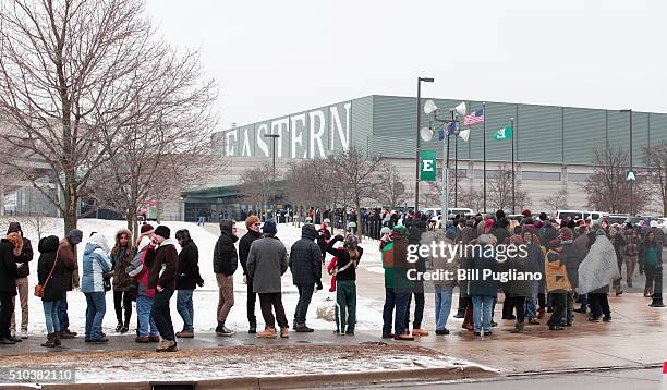 People wait in line in the cold to get into U.S. Senator and Democratic Presidential Candidate Bernie Sanders first campaign rally in Michigan at...