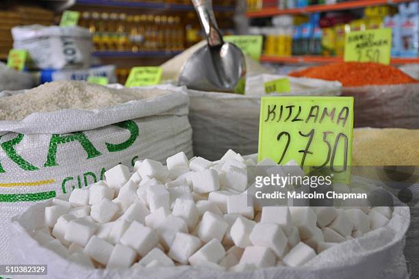 Sugar sold loose by weight from sacks in a grocery store in Bergama, Turkey. Kitlama style tea is where the drinker holds the oblong sugar cube...