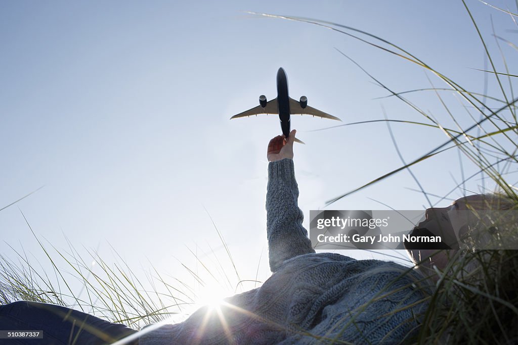 Teenage girl holding model aeroplane