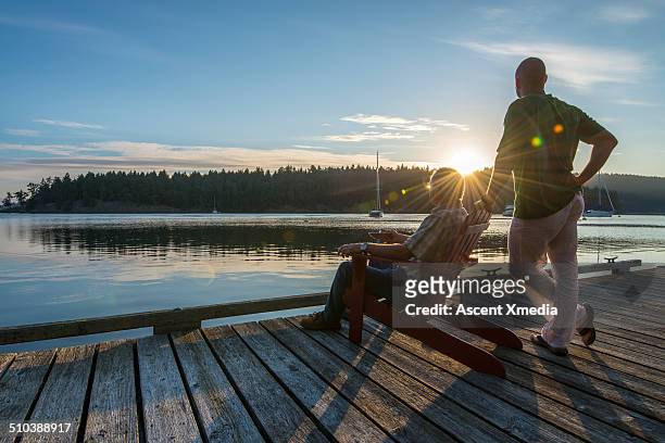 father and son look out to sunrise, seaside venada - canadian senior men stock pictures, royalty-free photos & images