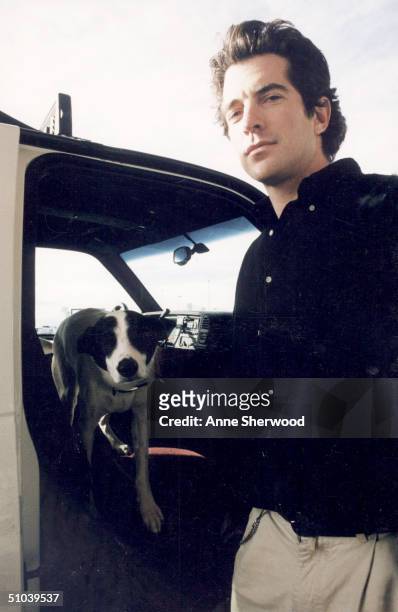 John F. Kennedy Jr. Gets Out Of A Truck With His Pet Dog "Friday," December 30, 1996 At A Montana Airport. July 16, 2000 Marks The One-Year...