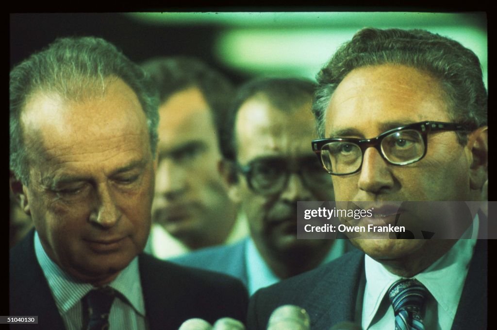 Former Secretary Of State Henry Kissinger Speaks While Standing Next To Israeli Leader Yi...