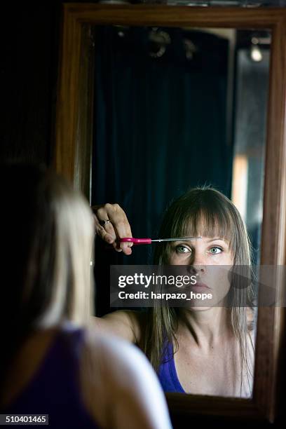 woman cutting her bangs - standing mirror stock pictures, royalty-free photos & images