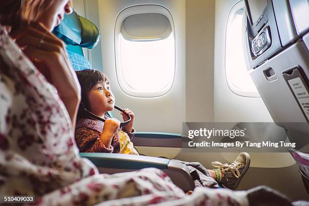 mom & child riding on the airplane - airplane interior stockfoto's en -beelden