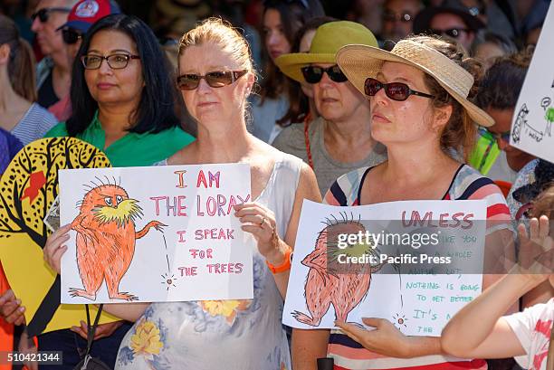 Protesters hold signs at the community led rally on Valentine's Day in the hope of saving at least 800 trees from clearing or damage for construction...